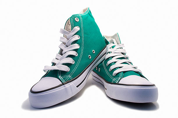 pair of green sneakers a pair of green vintage shoes isolated on white background canvas shoe photos stock pictures, royalty-free photos & images