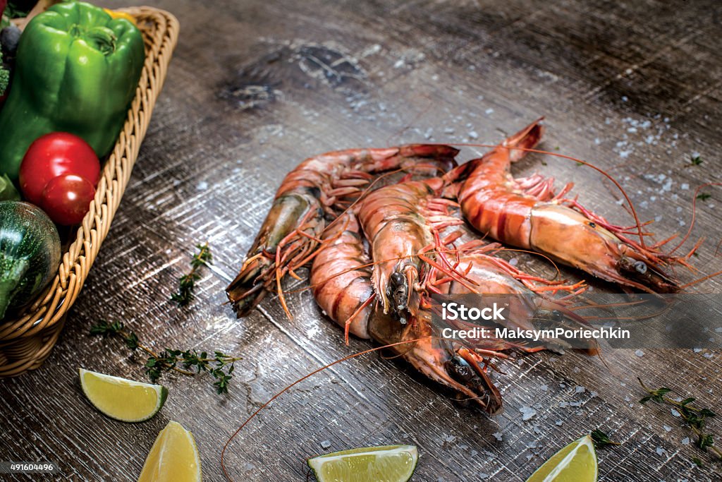 Seafood prawns. Fresh beautiful large sea jumbo prawns. Deliciou Seafood prawns. Fresh beautiful large sea jumbo prawns. Delicious shrimps on a wooden table. 2015 Stock Photo