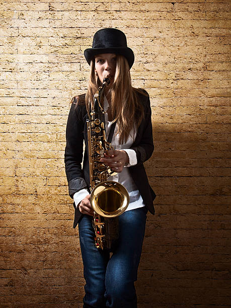 istock young beautiful woman with saxophone 491605849