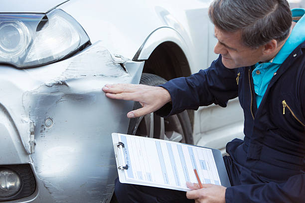 istock Auto Workshop Mechanic Inspecting Damage To Car 491606112