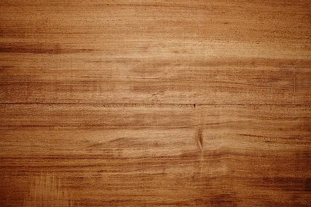 Photo of Overhead view of light brown wooden table