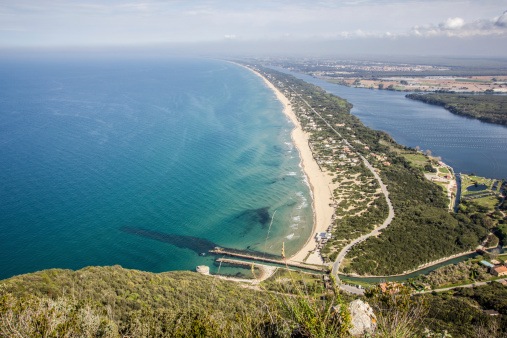 View of coastal sand strip and Lake Paola from the limestone cliffs of the Mount Circeo, Lazio, Italy.