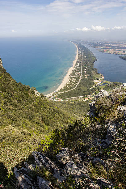 View of beach, lake and clear sea from Mount Circeo View of coastal sand strip and Lake Paola from the limestone cliffs of the Mount Circeo, Lazio, Italy. sabaudia stock pictures, royalty-free photos & images
