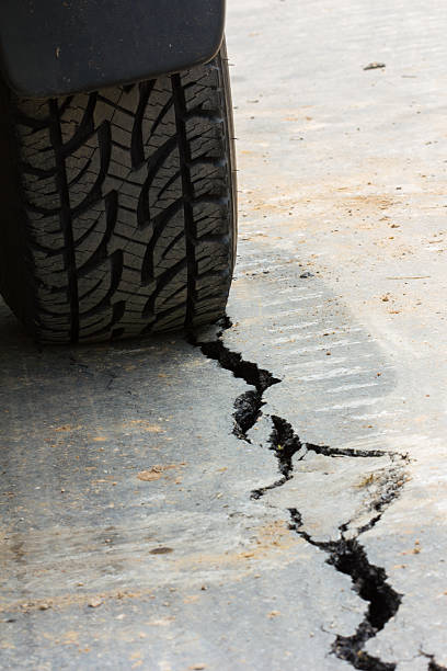 istock back view of tire tread and cracked asphalt 491608231