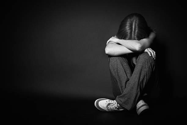 istock woman in depression and despair crying on black dark 491609385
