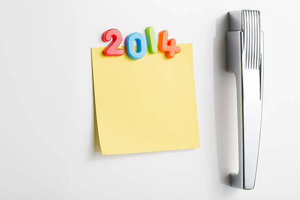 istock Refrigerator door with blank note and the year 2014 491610883