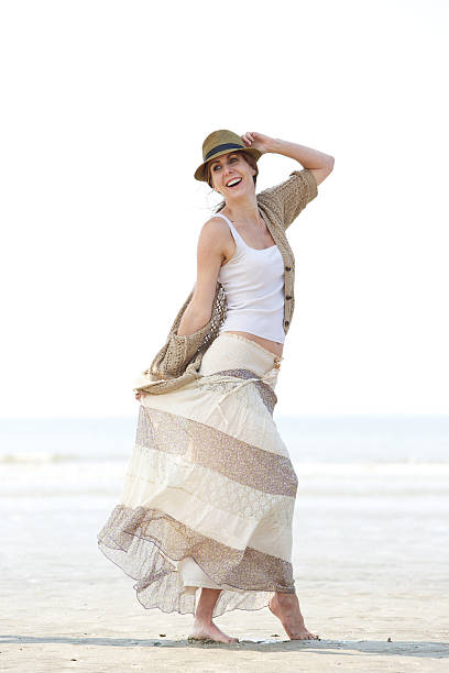 istock Cheerful mature woman walking on the beach 491611409