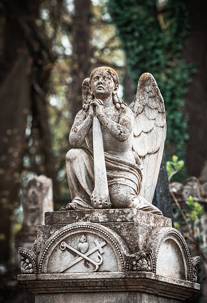 istock statue on grave in the old cemetery 491611789