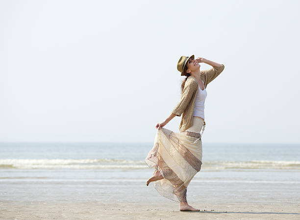 istock Woman enjoying a day at the beach 491613325