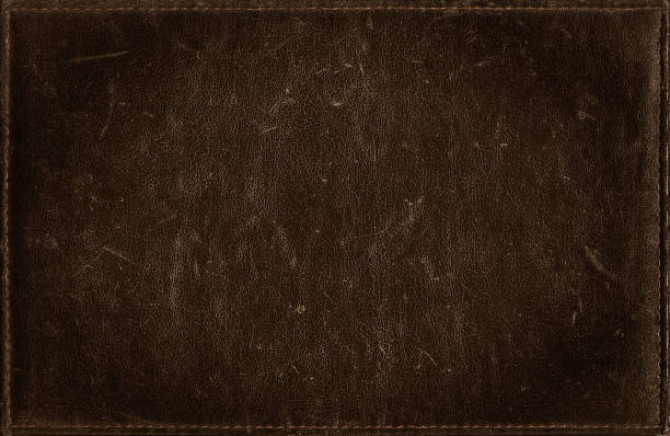 istock Dark brown background from distress leather texture with stitched frame 491616608