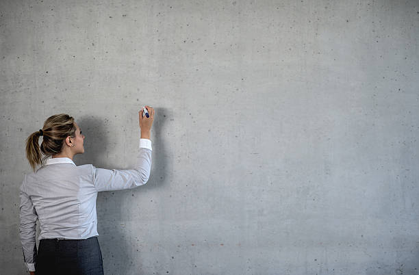istock Business woman writing on a board 491617634
