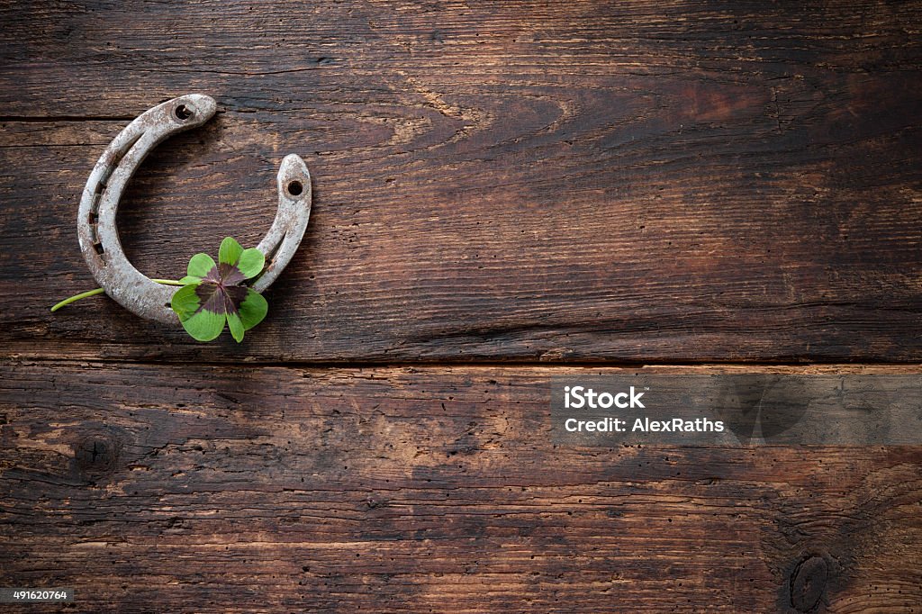St. Patricks day, lucky charms St. Patricks day, lucky charms. Four leaved clover and a horseshoe on wooden board Luck Stock Photo