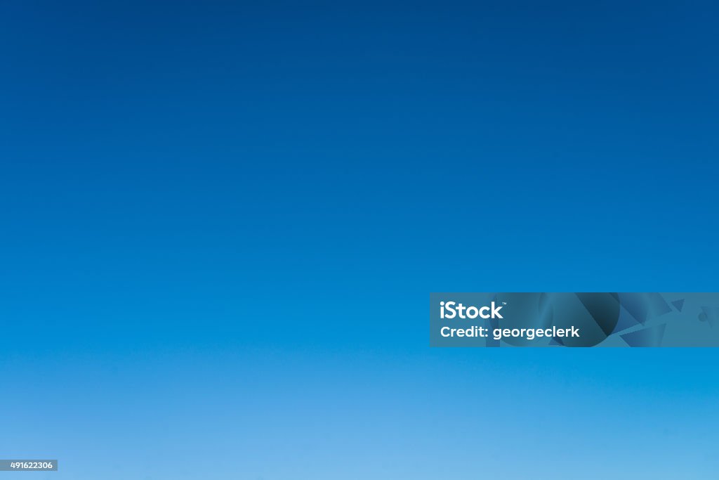 Cloudless empty blue sky background A graduated pure blue sky background, taken just above the horizon level. Blue Stock Photo