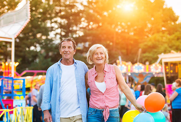 Senior couple having a good time at the fun fair