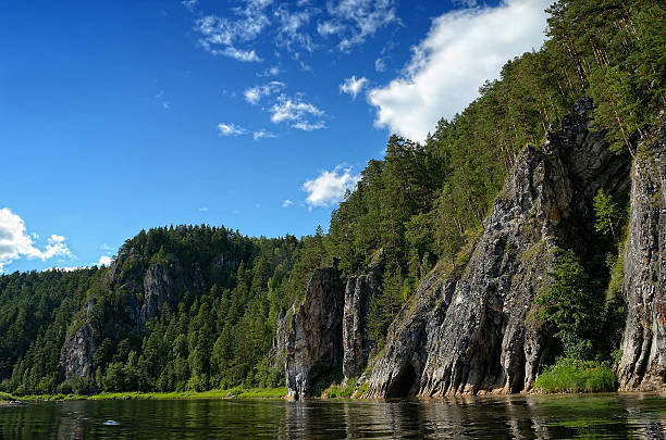 istock Rocky river forested on the background of blue cloudy sky 491628822