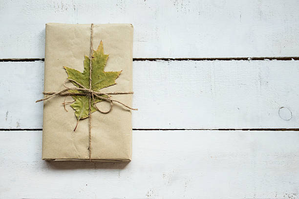 istock Christmas present and autumn leaf shot from above 491628824