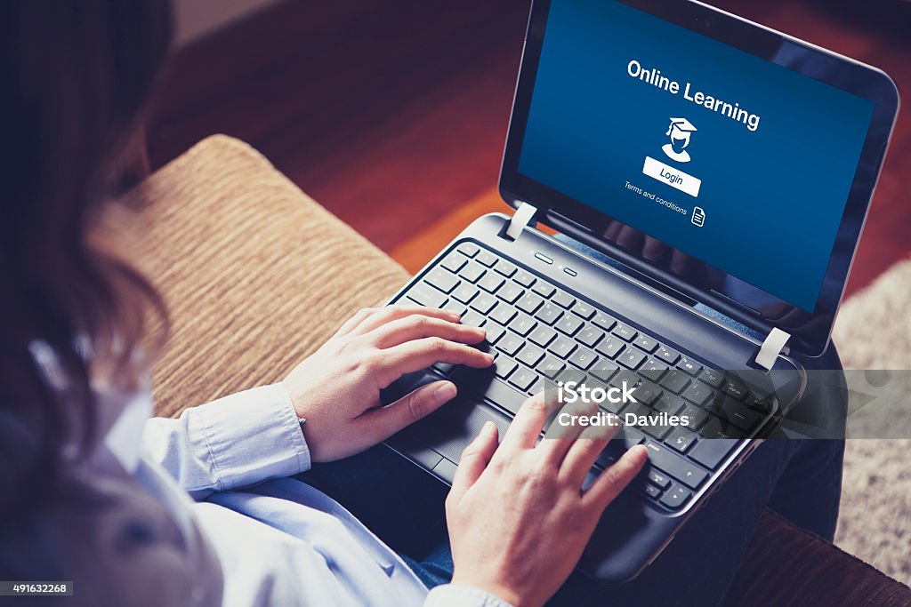 "Online Learning" on the screen. Woman hands over the laptop keyboard. Internet Stock Photo