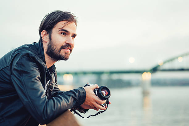 istock Photographer holding an old film camera 491632994