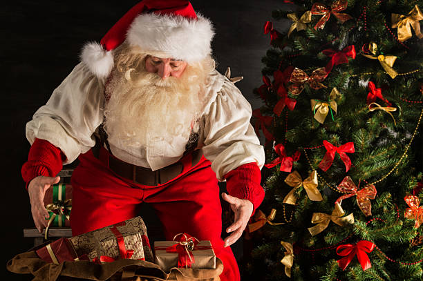 istock Santa Claus opening his sack and taking gifts 491633122