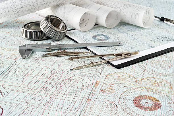 istock roller bearing, vernier callipers , compasses, clipboard and drawings 491633974