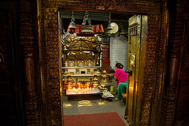Kathmandu, Nepal - October 6, 2015: Lady giving blessings in a small temple in Kathmandu, Nepal