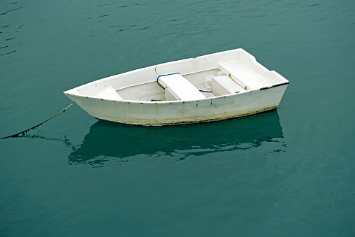 Small boat moored in estuary