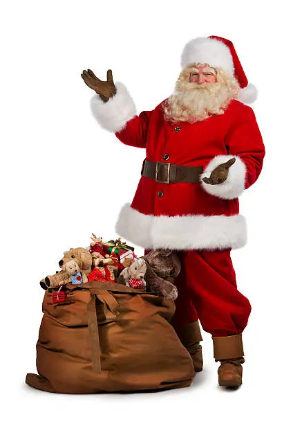 Photo of Santa Claus posing near a bag full of gifts