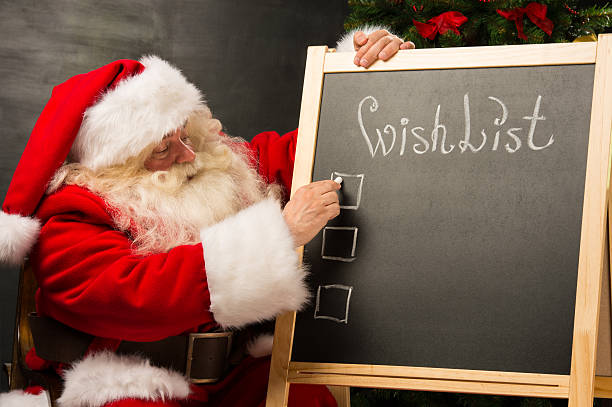 istock Santa Claus sitting near chalkboard 491641604