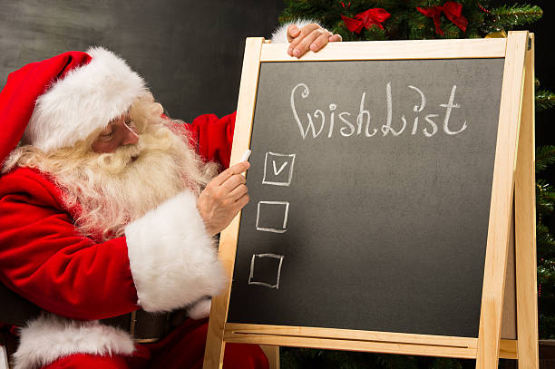 istock Santa Claus sitting near chalkboard 491641674