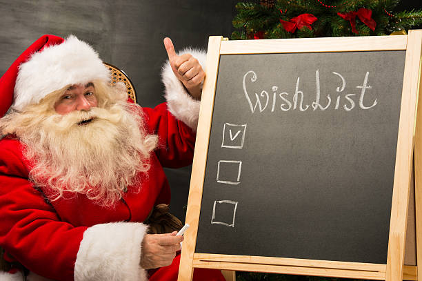 istock Santa Claus sitting near chalkboard 491641742