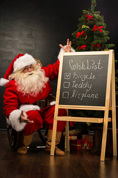 istock Santa Claus sitting near chalkboard 491641896