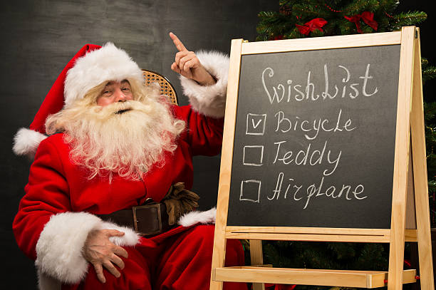 istock Santa Claus sitting near chalkboard 491641954