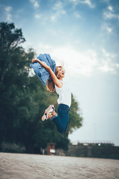 istock Young women joyfully jumping on the beach 491642460