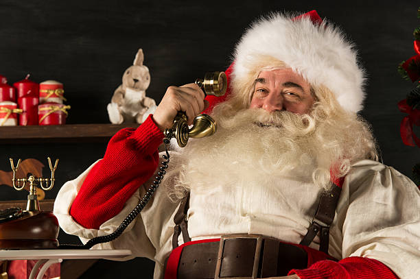 Santa Claus calling by vintage phone stock photo