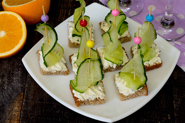 istock Appetizer canape sandwich with cucumber and cheese curd 491645338