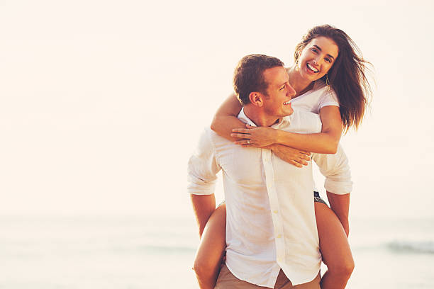 istock Young Romantic Couple Playing on the Beach 491653582