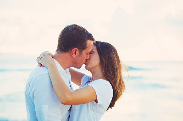 istock Young Couple Kissing on the Beach at Sunset 491653816