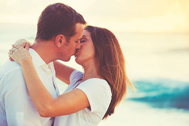 istock Young Couple Kissing on the Beach at Sunset 491653838