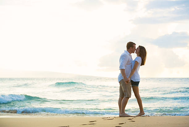 istock Young Couple Kissing on the Beach at Sunset 491653884