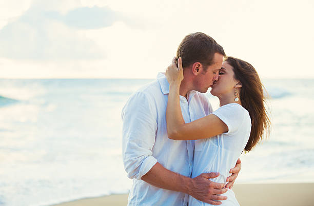 istock Young Couple Kissing on the Beach at Sunset 491653908
