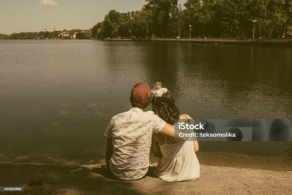 beautiful couple in the city beautiful couple sits on the lake in the city 2015 Stock Photo