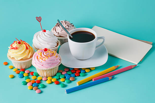 istock Cupcakes with colorful confetti and coffee cup 491654040