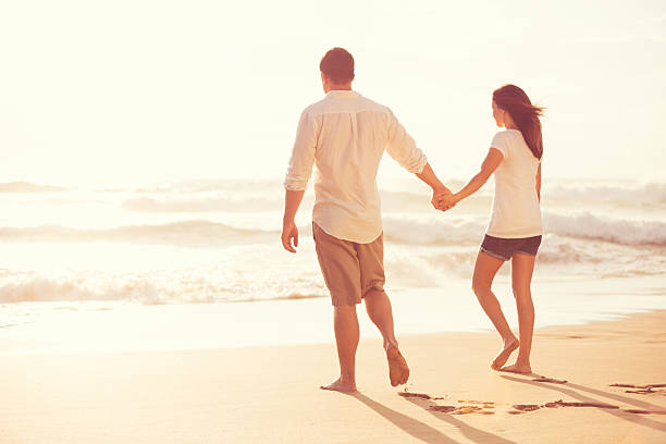 istock Romantic Young Couple on the Beach at Sunset 491654146