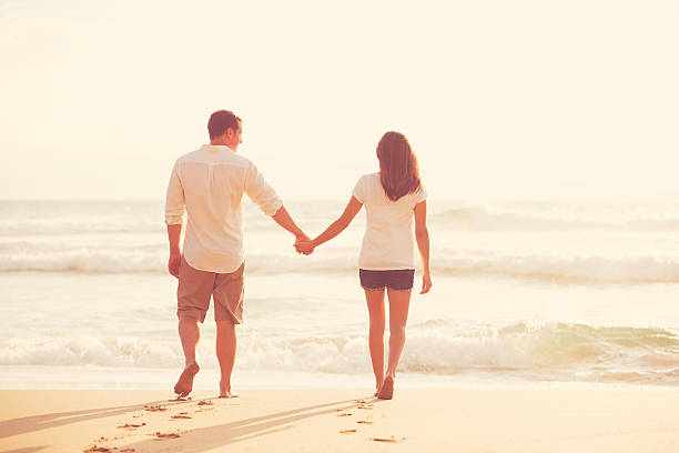 istock Romantic Young Couple on the Beach at Sunset 491654172