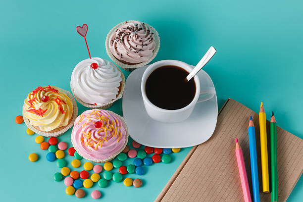 istock Cupcakes with colorful confetti and coffee cup 491655080
