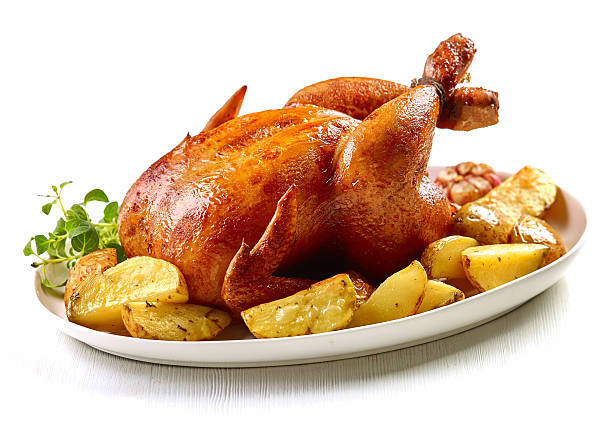 roasted chicken roasted chicken and potatoes on white plate celebrity roast stock pictures, royalty-free photos & images