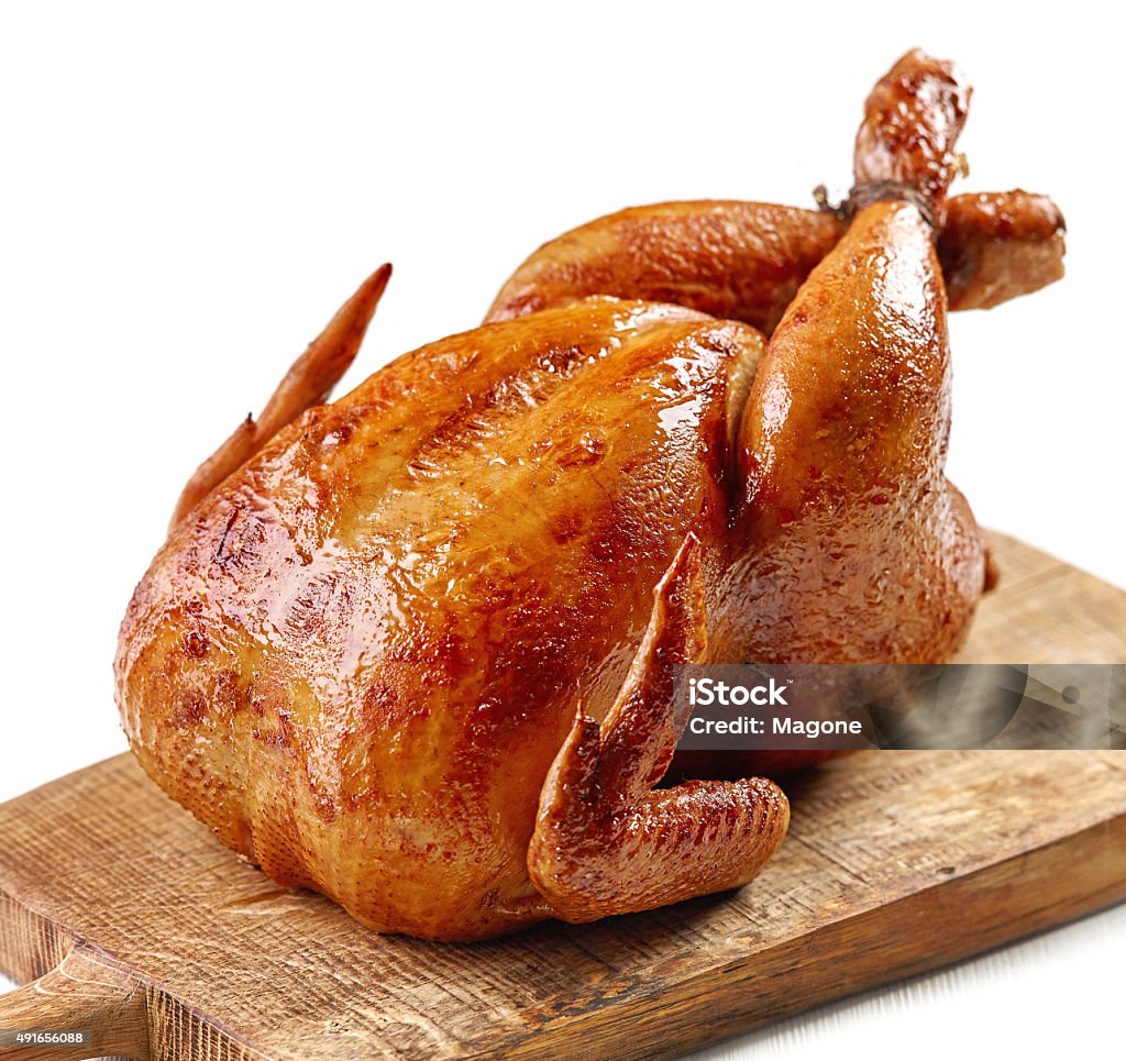 roasted chicken roasted chicken on wooden cutting board 2015 Stock Photo