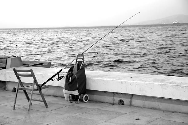 Izmir,Turkey- October 4, 2015: A Fishing rod and empty chair are standing in Guzelyalı coast in Izmir.