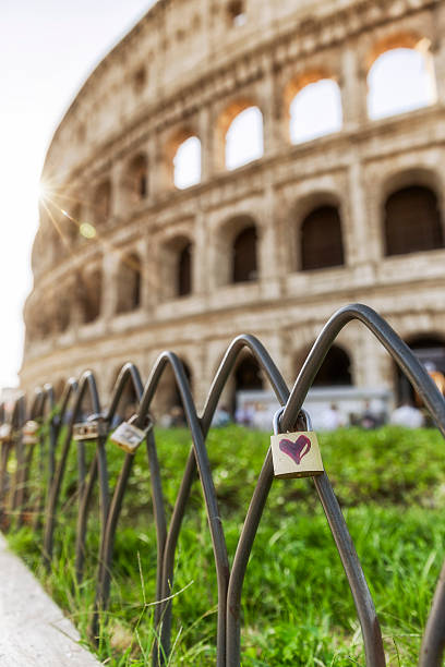 Red heart on a padlock in front of the Colosseum stock photo