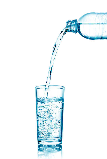istock Water pouring from bottle into the glass 491657182